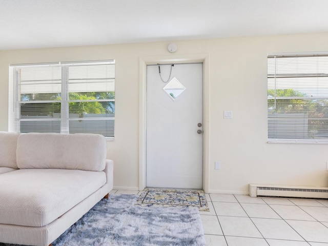 tiled foyer with a baseboard heating unit and plenty of natural light