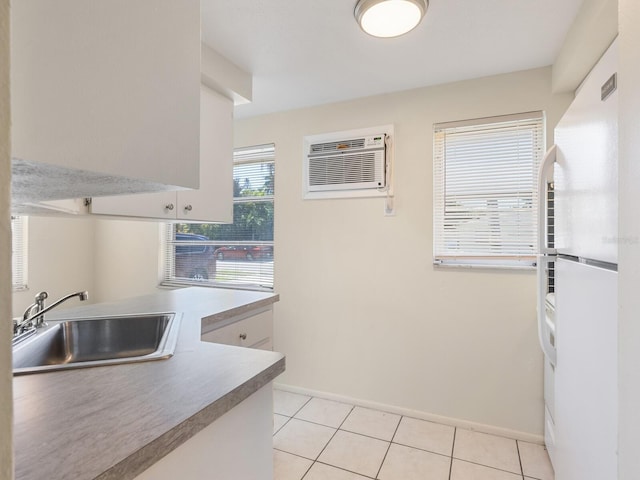 kitchen featuring light tile patterned floors, white refrigerator, a wall mounted air conditioner, and sink