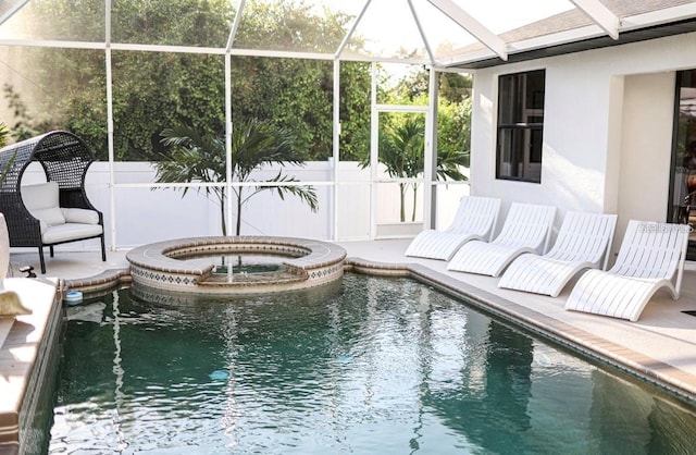 view of pool with an in ground hot tub, a patio, and glass enclosure