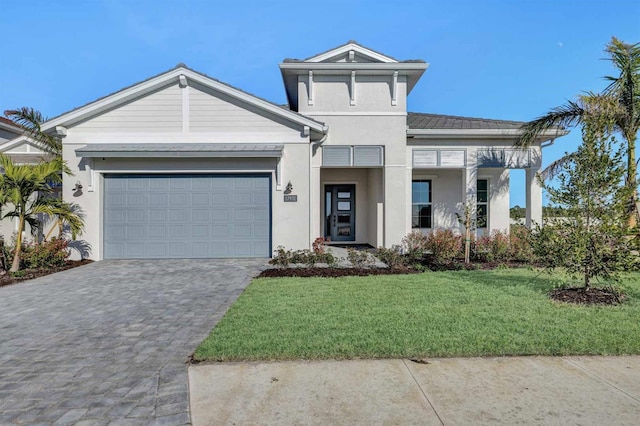 view of front of property with a garage and a front lawn