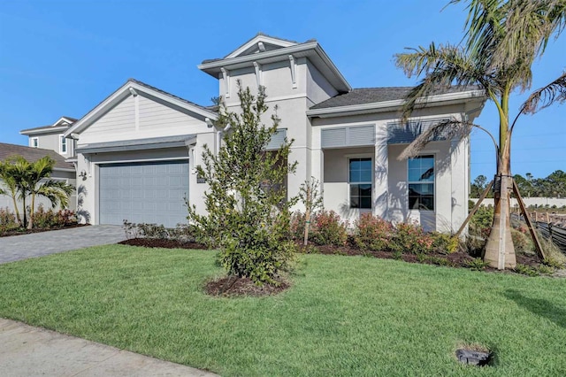 view of front of property featuring a garage and a front lawn