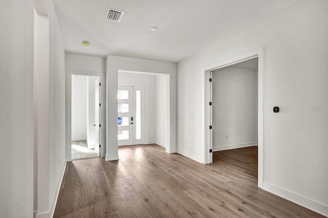 unfurnished room featuring hardwood / wood-style flooring and french doors