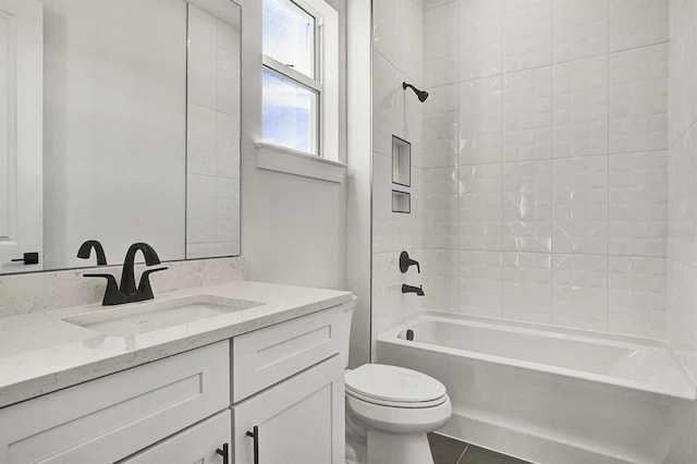 full bathroom featuring vanity, tile patterned floors, tiled shower / bath combo, and toilet