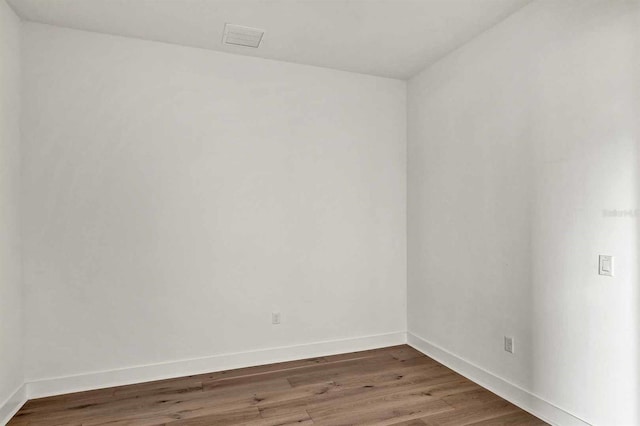 unfurnished room featuring dark hardwood / wood-style flooring