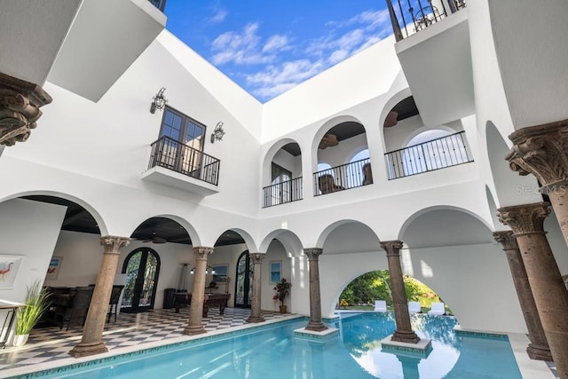 view of pool featuring ceiling fan and a patio