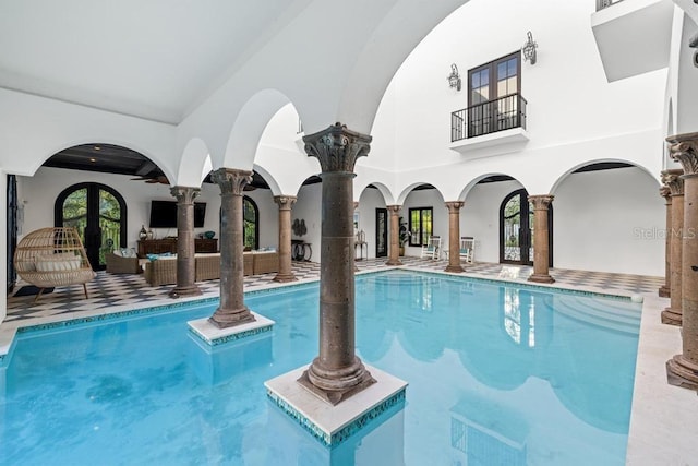 view of pool with outdoor lounge area, ceiling fan, and a patio