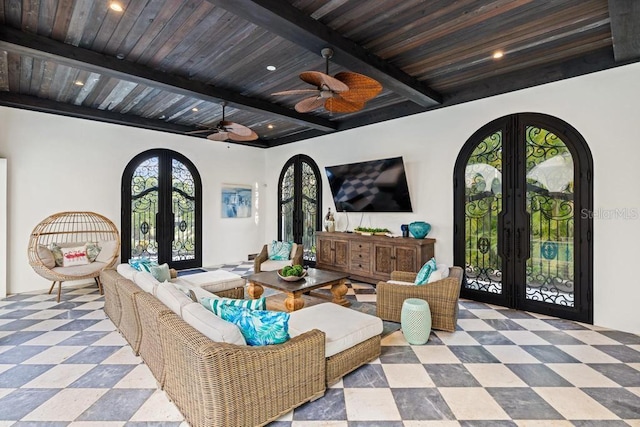 living room featuring french doors, beamed ceiling, and wooden ceiling