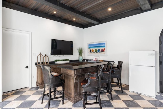 bar with beamed ceiling, white refrigerator, and wood ceiling