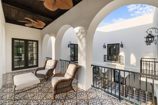 balcony with ceiling fan and french doors