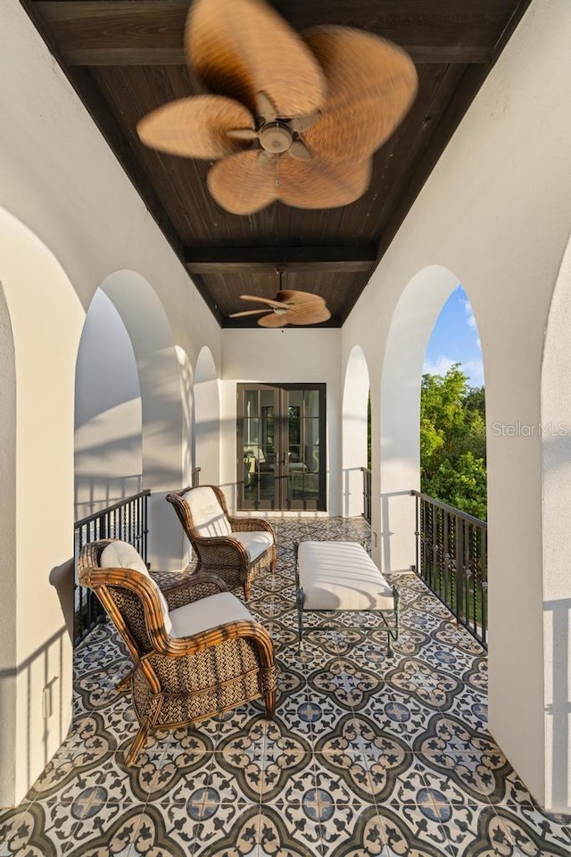 view of patio / terrace featuring french doors, a balcony, and ceiling fan