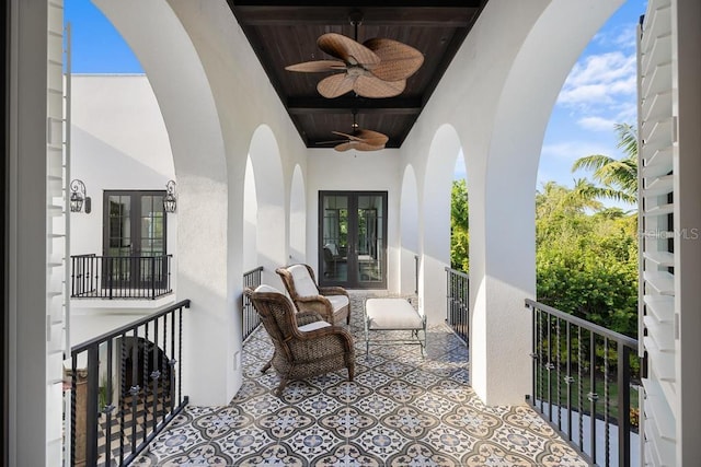 balcony featuring ceiling fan and french doors