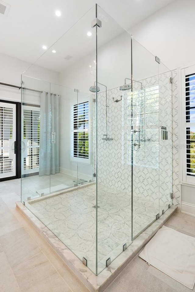 bathroom with tile patterned flooring and walk in shower