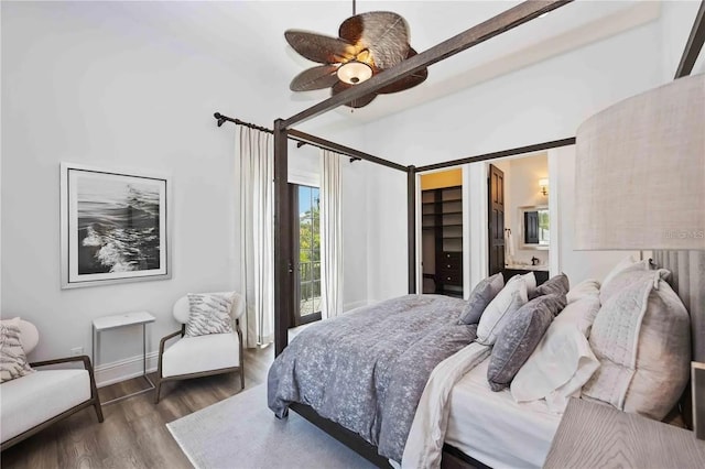 bedroom featuring ceiling fan, dark hardwood / wood-style floors, ensuite bathroom, a walk in closet, and a closet