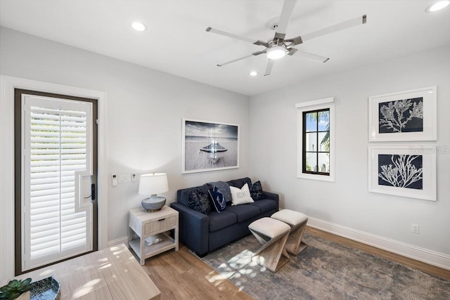 living room featuring a wealth of natural light, ceiling fan, and hardwood / wood-style flooring