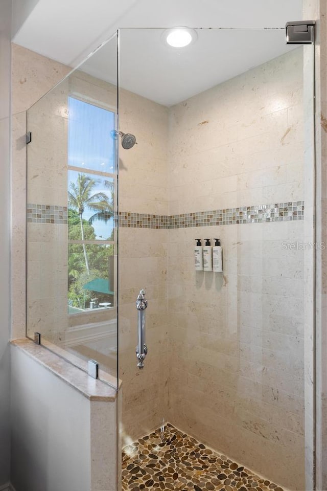 bathroom with tiled shower