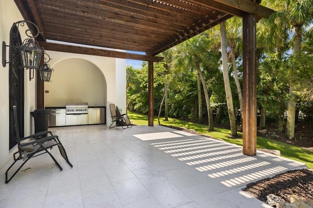 view of patio with an outdoor kitchen, a grill, and a pergola