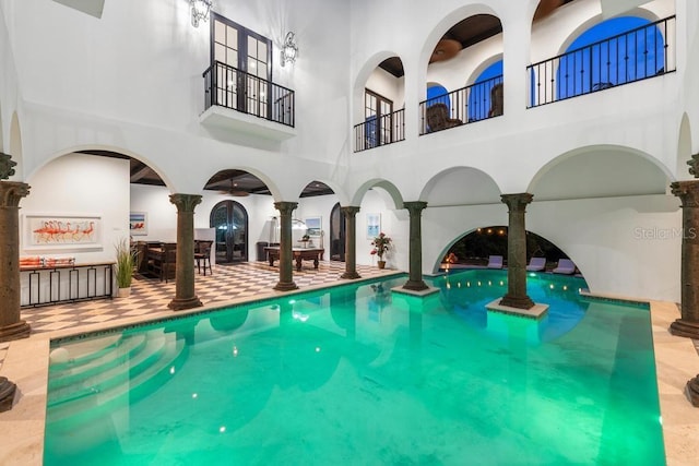 view of swimming pool featuring decorative columns