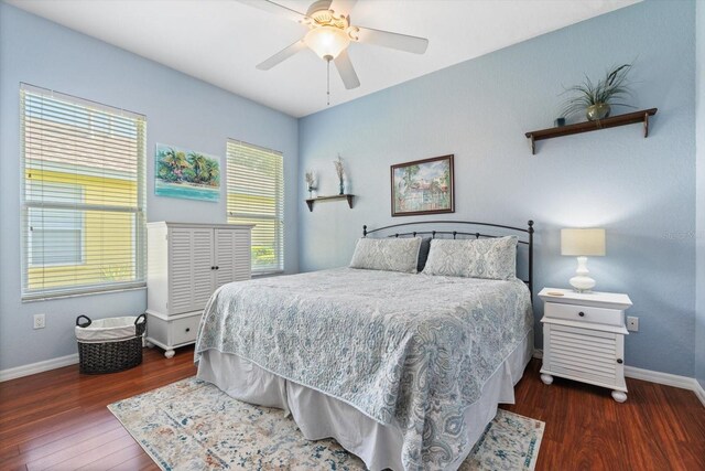 bedroom with ceiling fan and dark wood-type flooring