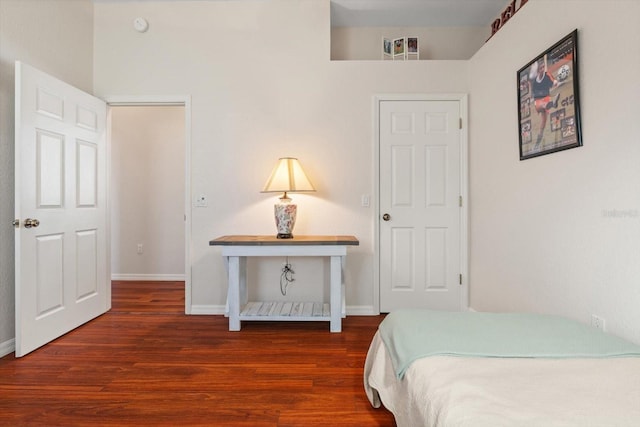 bedroom with dark hardwood / wood-style flooring