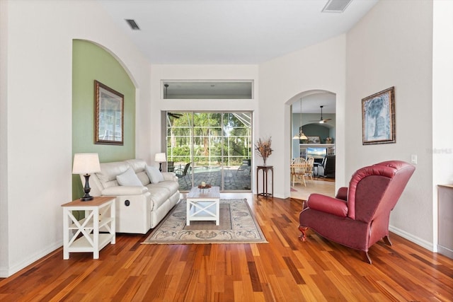 living room with hardwood / wood-style flooring and ceiling fan