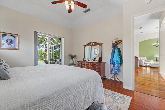 1206 86th Ct NW, Bradenton, FL 34209 - bedroom with wood finished floors, access to exterior, a chandelier, and ceiling fan