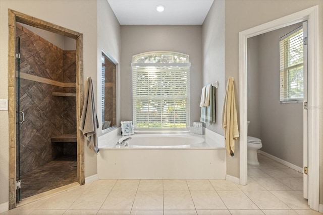 bathroom with tile patterned floors, separate shower and tub, and toilet