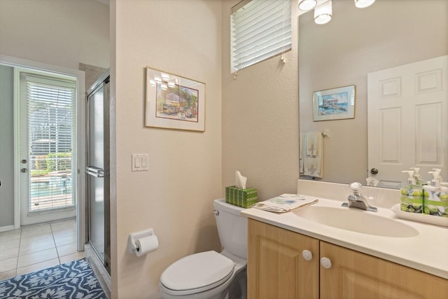 bathroom featuring tile patterned flooring, vanity, toilet, and a wealth of natural light