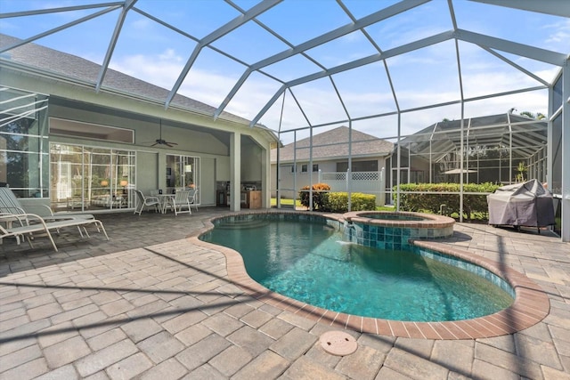 view of pool with an in ground hot tub, area for grilling, a lanai, ceiling fan, and a patio area