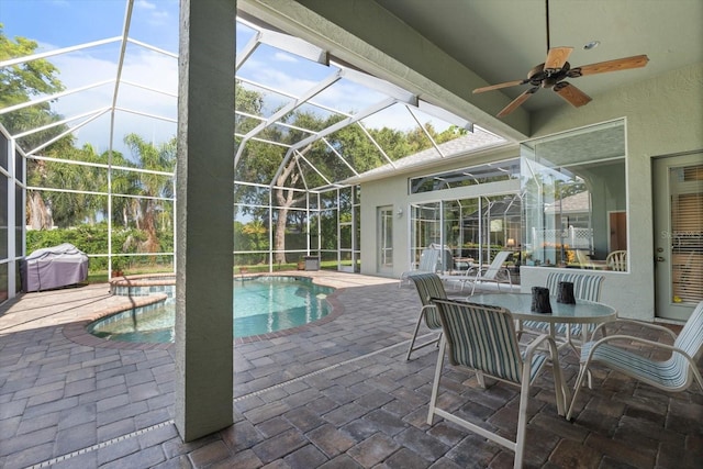 view of pool featuring a patio, a hot tub, ceiling fan, and a lanai