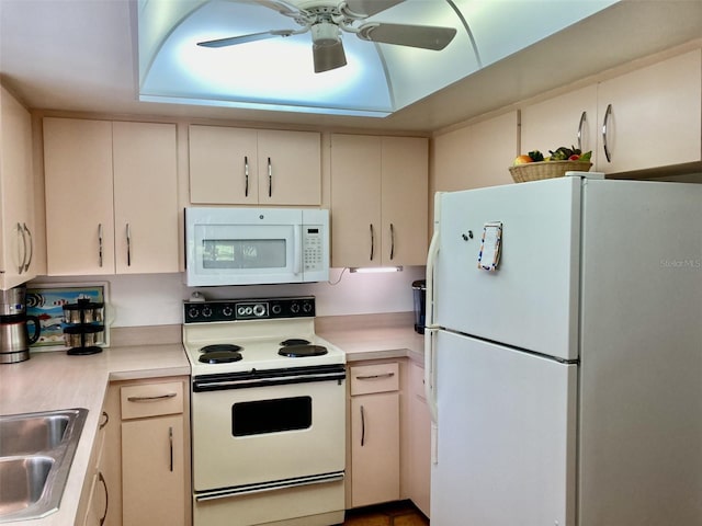 kitchen with cream cabinets, white appliances, ceiling fan, and sink