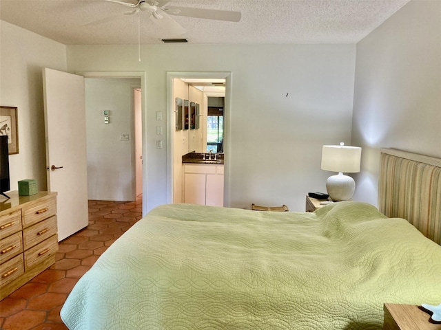 tiled bedroom with a textured ceiling and ceiling fan