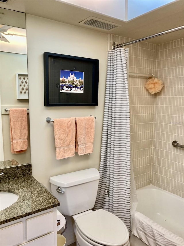 full bathroom featuring shower / bath combo, vanity, and toilet