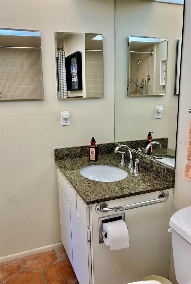 bathroom featuring walk in shower, vanity, and toilet