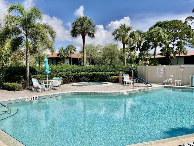 view of pool featuring a patio and a hot tub