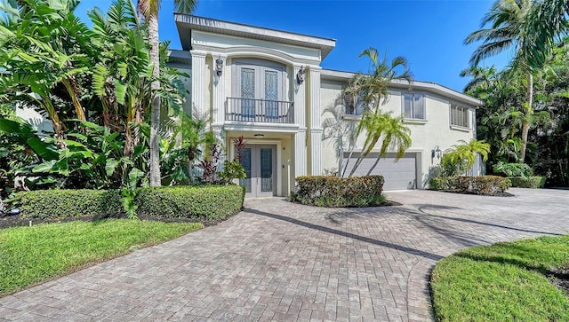 view of front of property with a garage and a balcony