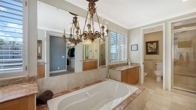 full bathroom with toilet, separate shower and tub, tile patterned floors, crown molding, and vanity