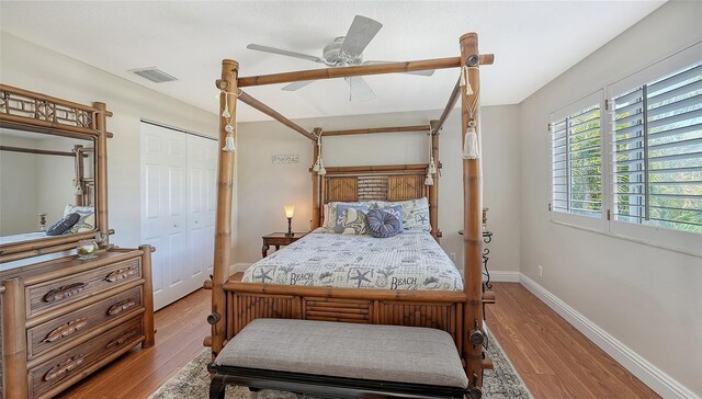 bedroom featuring wood-type flooring, ceiling fan, and a closet