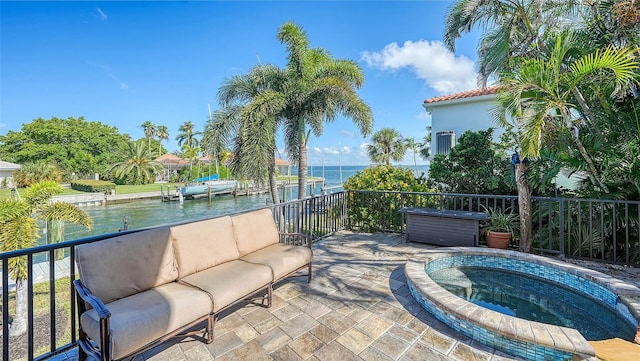 exterior space with a water view and an in ground hot tub