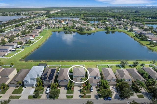 drone / aerial view with a residential view and a water view