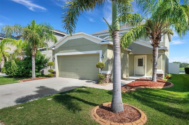 view of front of property with a garage, concrete driveway, a front lawn, and stucco siding