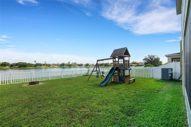 view of playground featuring a water view, a lawn, and a fenced backyard