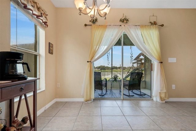 dining space with an inviting chandelier, plenty of natural light, and light tile patterned floors