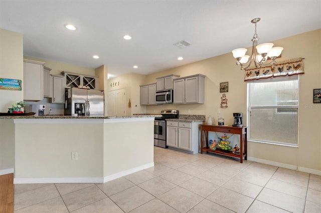 kitchen with stainless steel appliances, dark stone countertops, gray cabinets, and visible vents