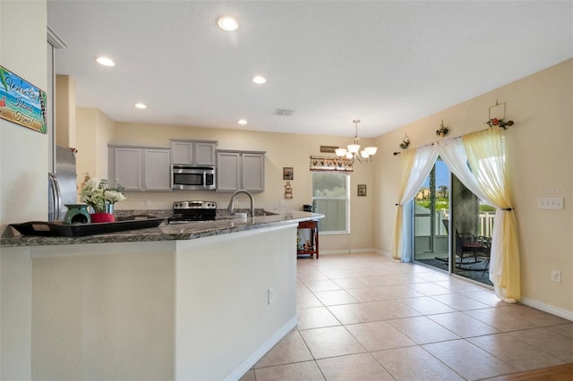 kitchen with light tile patterned floors, visible vents, hanging light fixtures, gray cabinets, and stainless steel appliances