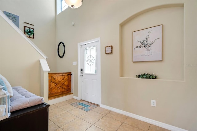 entryway featuring light tile patterned floors and baseboards