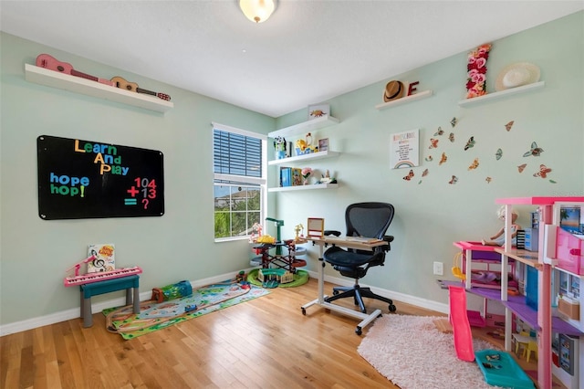 office area with baseboards and wood finished floors