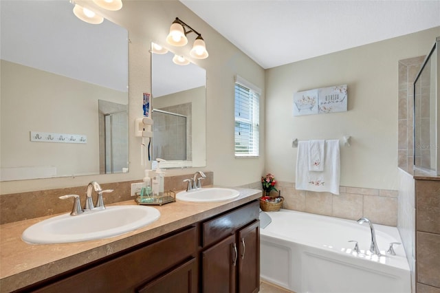 full bath featuring a garden tub, double vanity, a sink, and a shower stall