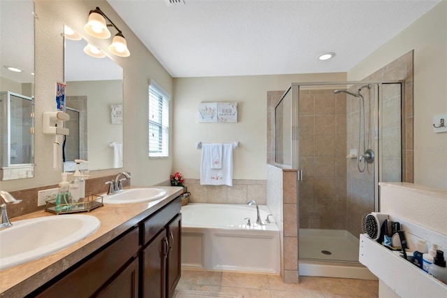 bathroom with a garden tub, tile patterned flooring, a sink, and a shower stall