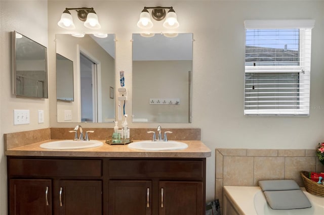 bathroom featuring double vanity, a sink, and a tub