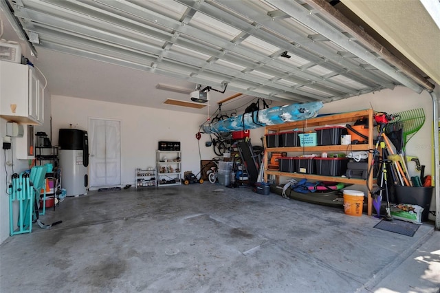 garage with electric water heater and a garage door opener